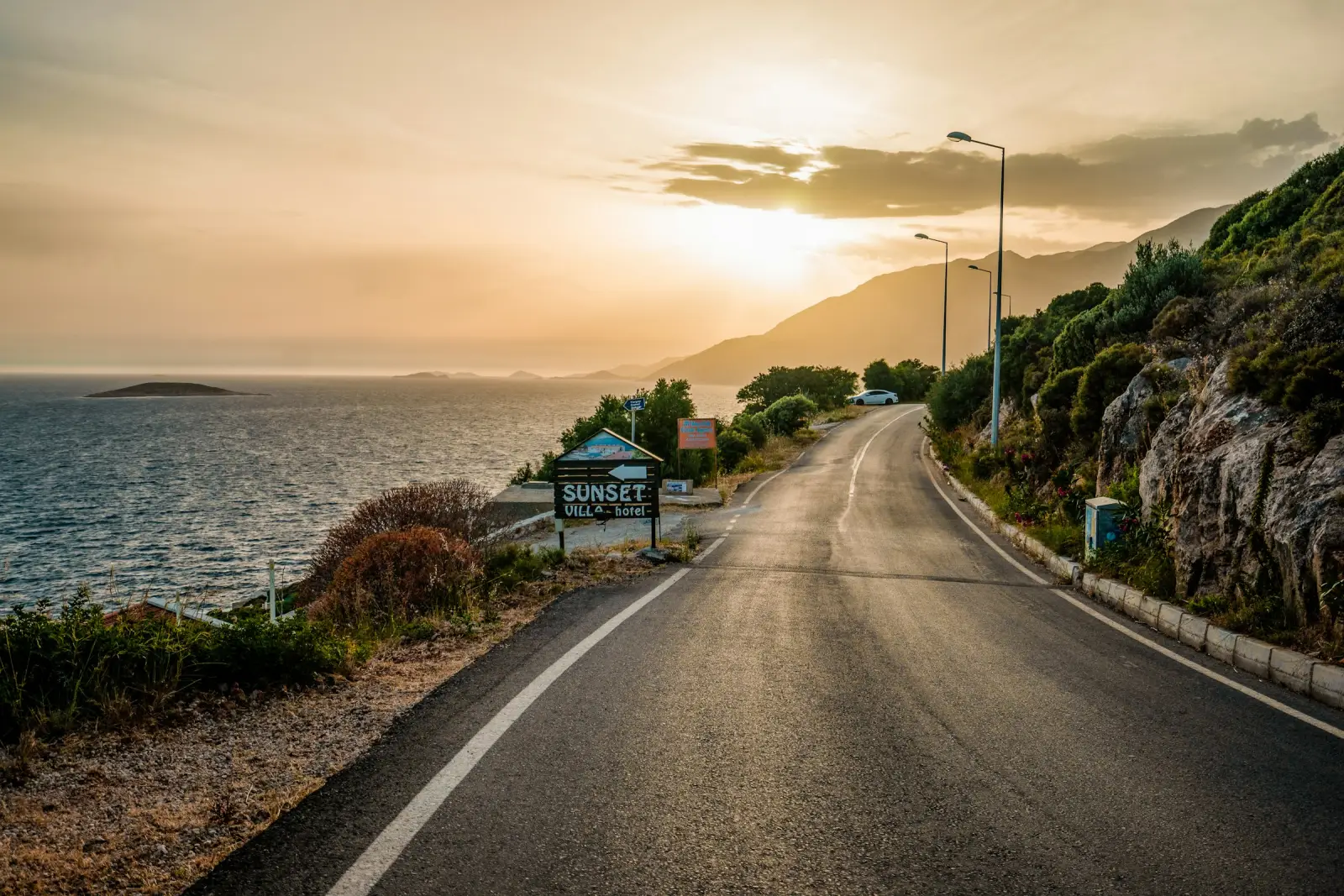A coastal road along the Mediterranean at sunset near Kaş